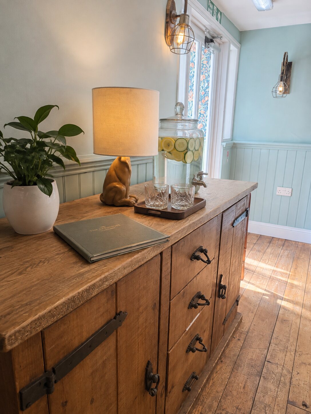 A characterful wooden sideboard with infused water and menus