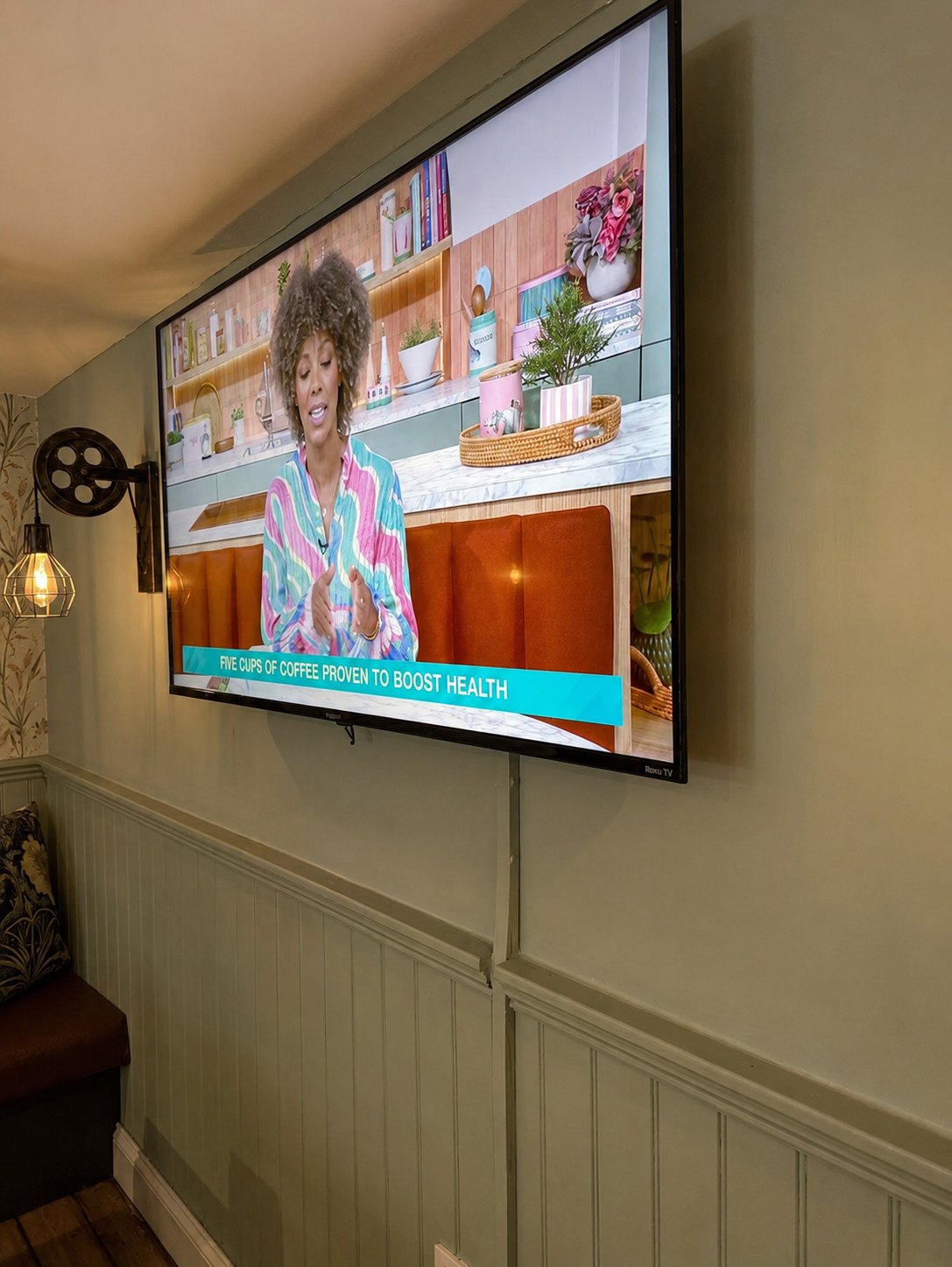 The pub television and warm vintage wall light